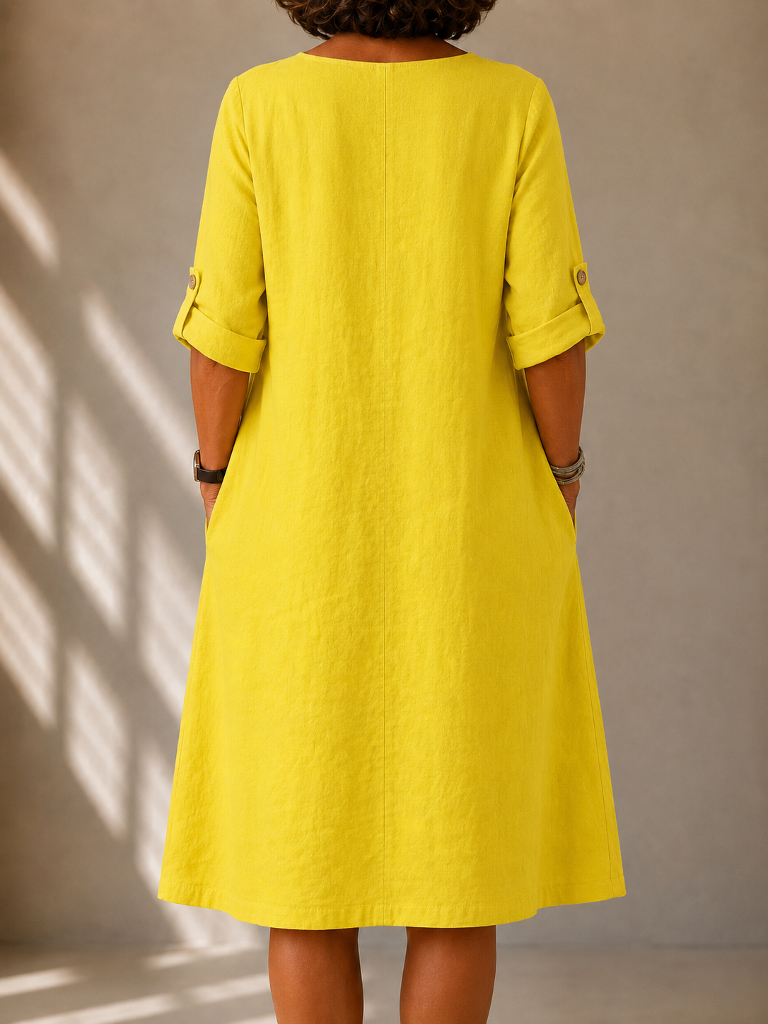 Back view of the Leona dress in Yellow, showing the straight A-line drape