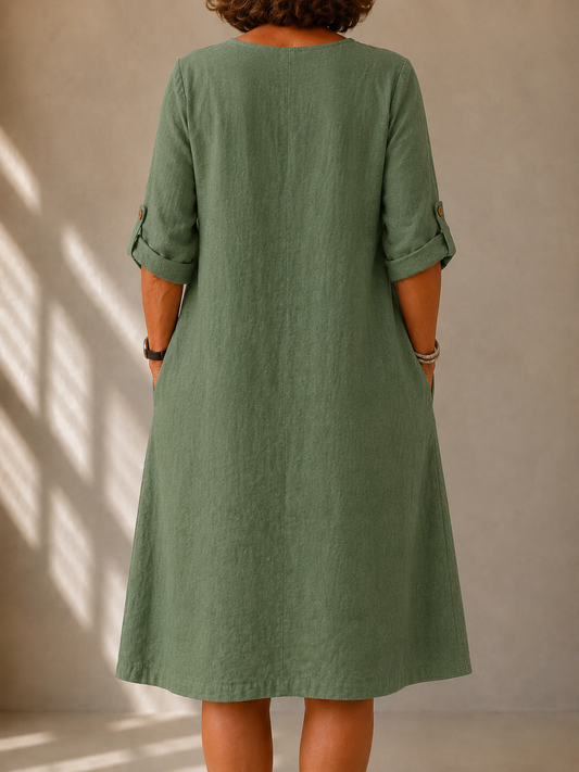 Back view of the Alma dress in Sage Green, showing the A-line drape