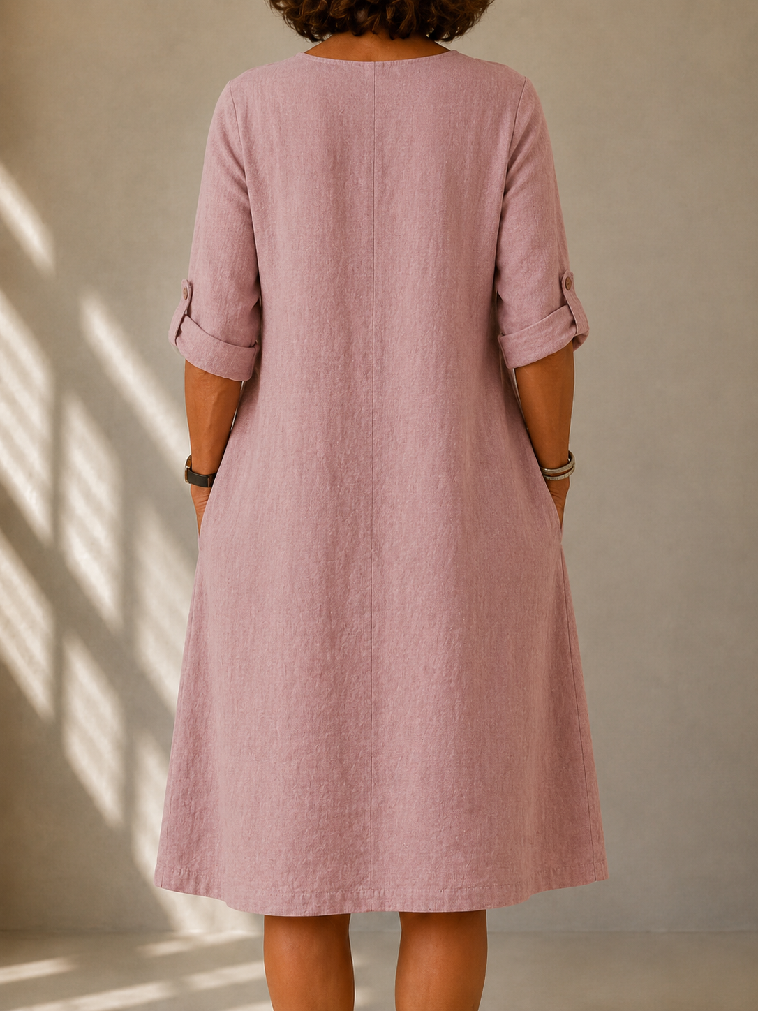 Back view of the Doris dress in Dusty Pink, showing the A-line drape