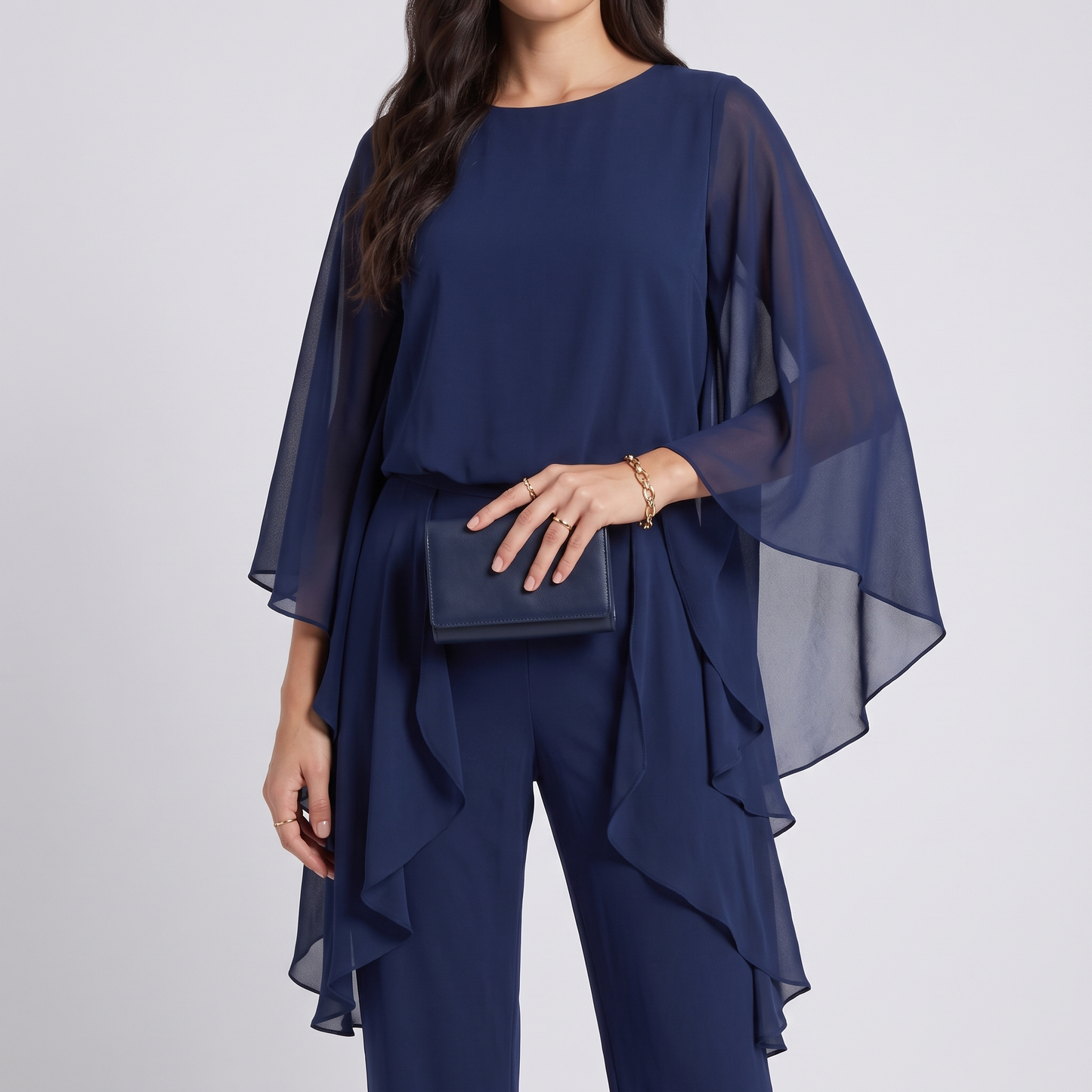 Close view of the flared chiffon sleeve and the ruffled overlay at the waist