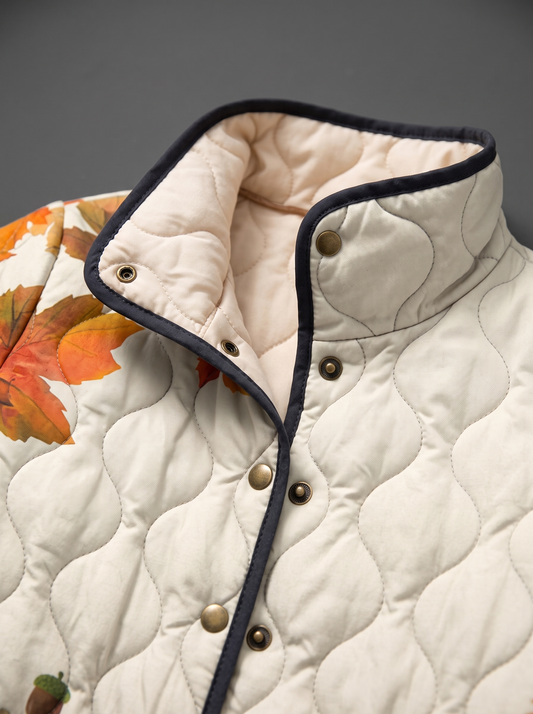 Close view of the stand collar, brass snaps and cream quilted lining on the Maude jacket