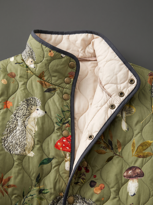 Close view of the stand collar, brass snaps and cream quilted lining on the Fern jacket