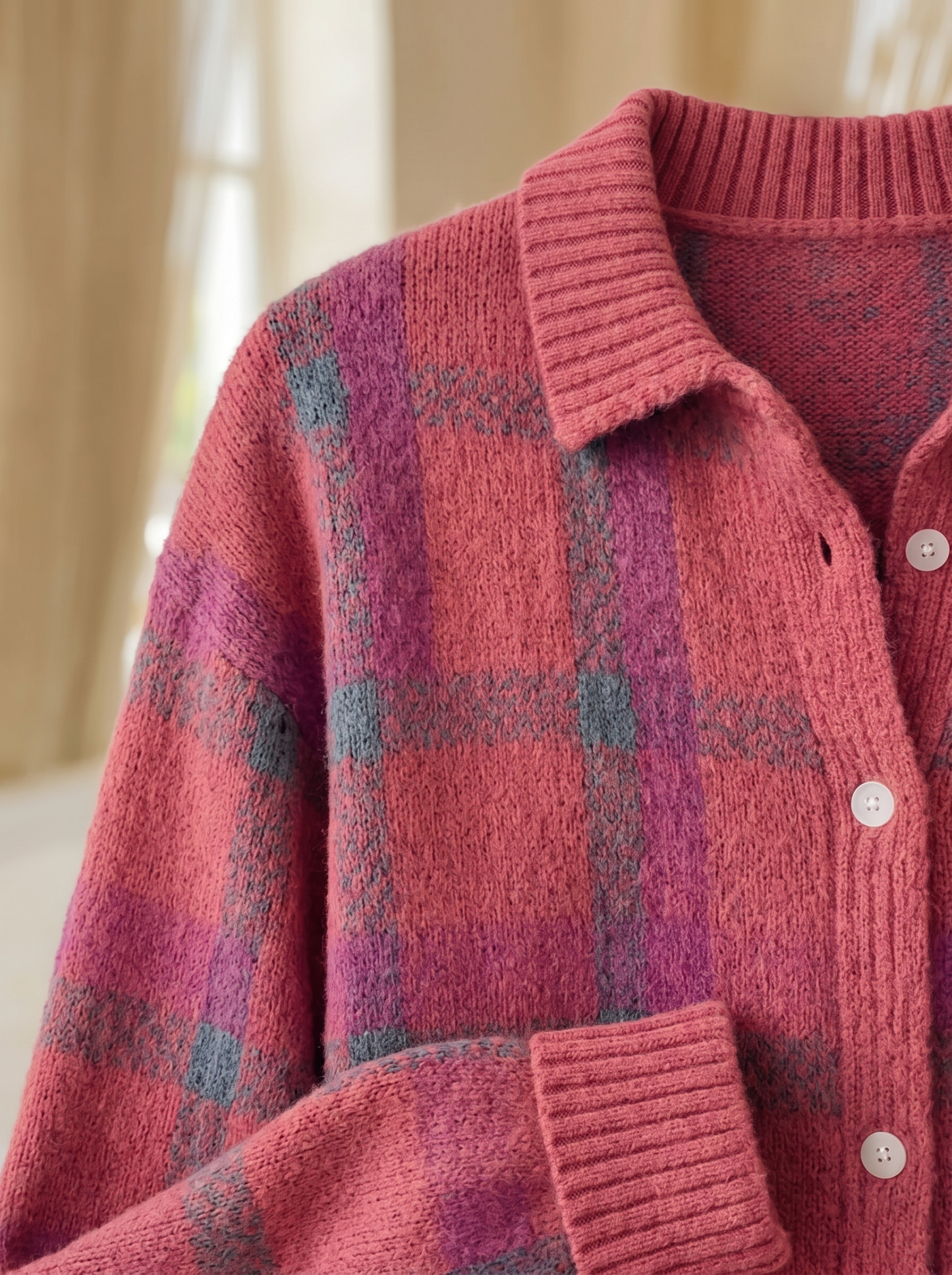 Close view of the collar, buttons and ribbed cuff on the Nola plaid cardigan