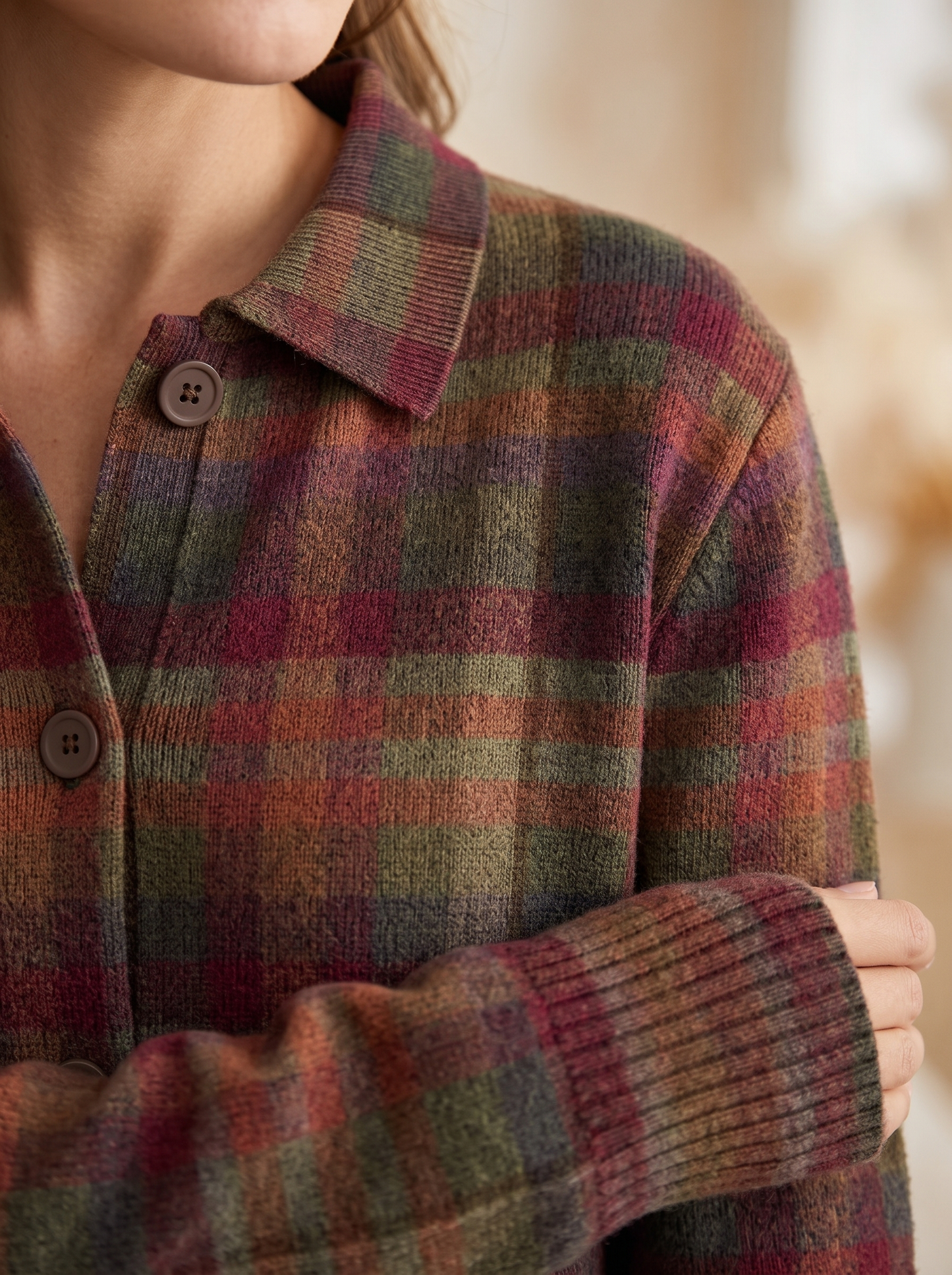 Close view of the collar, brown buttons and ribbed cuff on the Cornelia plaid cardigan