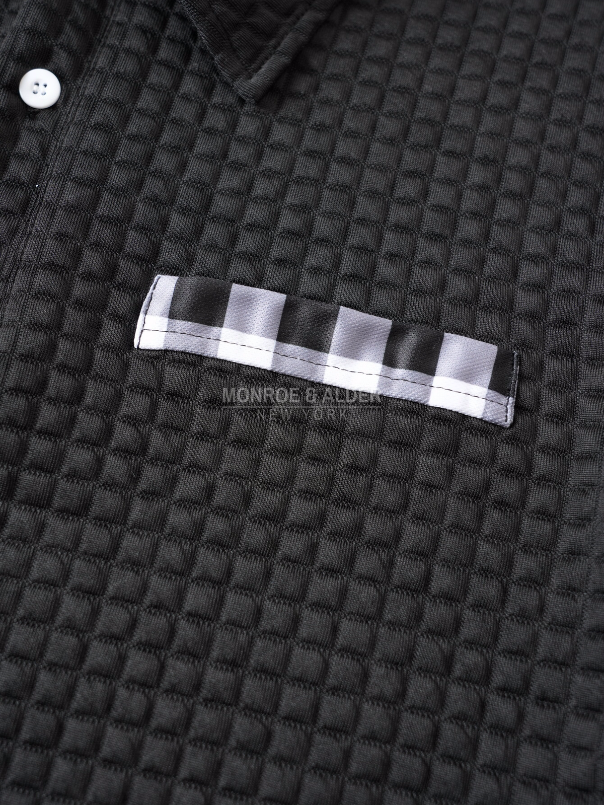 Close view of the plaid front pocket detail