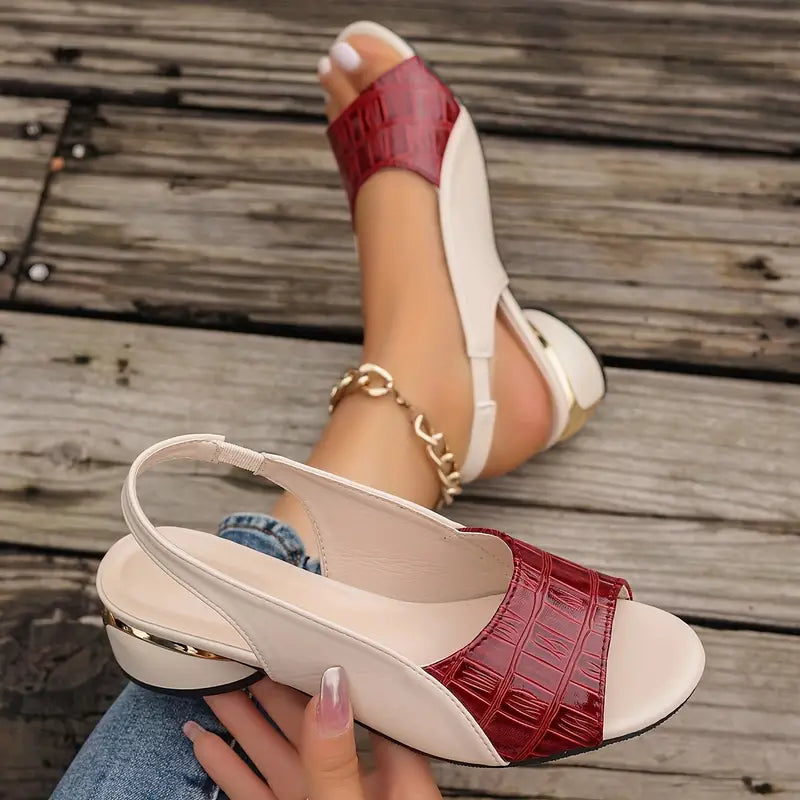 Close view of the elastic slingback strap and the gold-trimmed block heel
