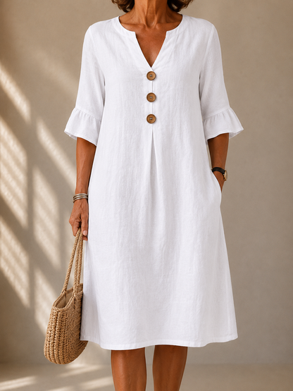 Pearl dress in White, front view showing the notched neckline and three wood-tone buttons