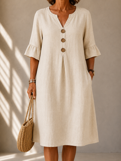 Geraldine dress in Beige, front view with notched neckline and three wood-tone buttons