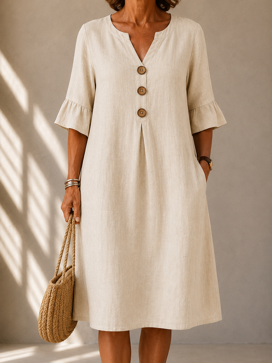 Geraldine dress in Beige, front view with notched neckline and three wood-tone buttons