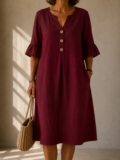 Rosalie dress in Burgundy, front view showing the notched neckline and three wood-tone buttons