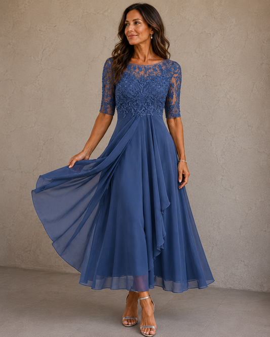 Elaine chiffon dress in Dusty Blue, full front view with the skirt held out