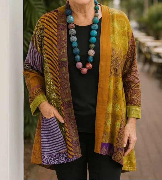 Blanche drape cardigan in Mustard, styled over black basics with one hand at the side