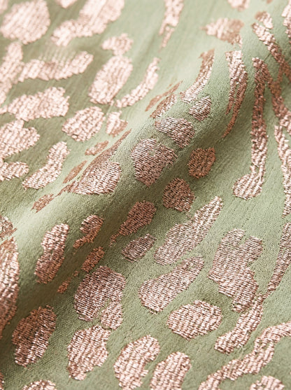 Fabric detail of the rose gold metallic leopard jacquard on sage green