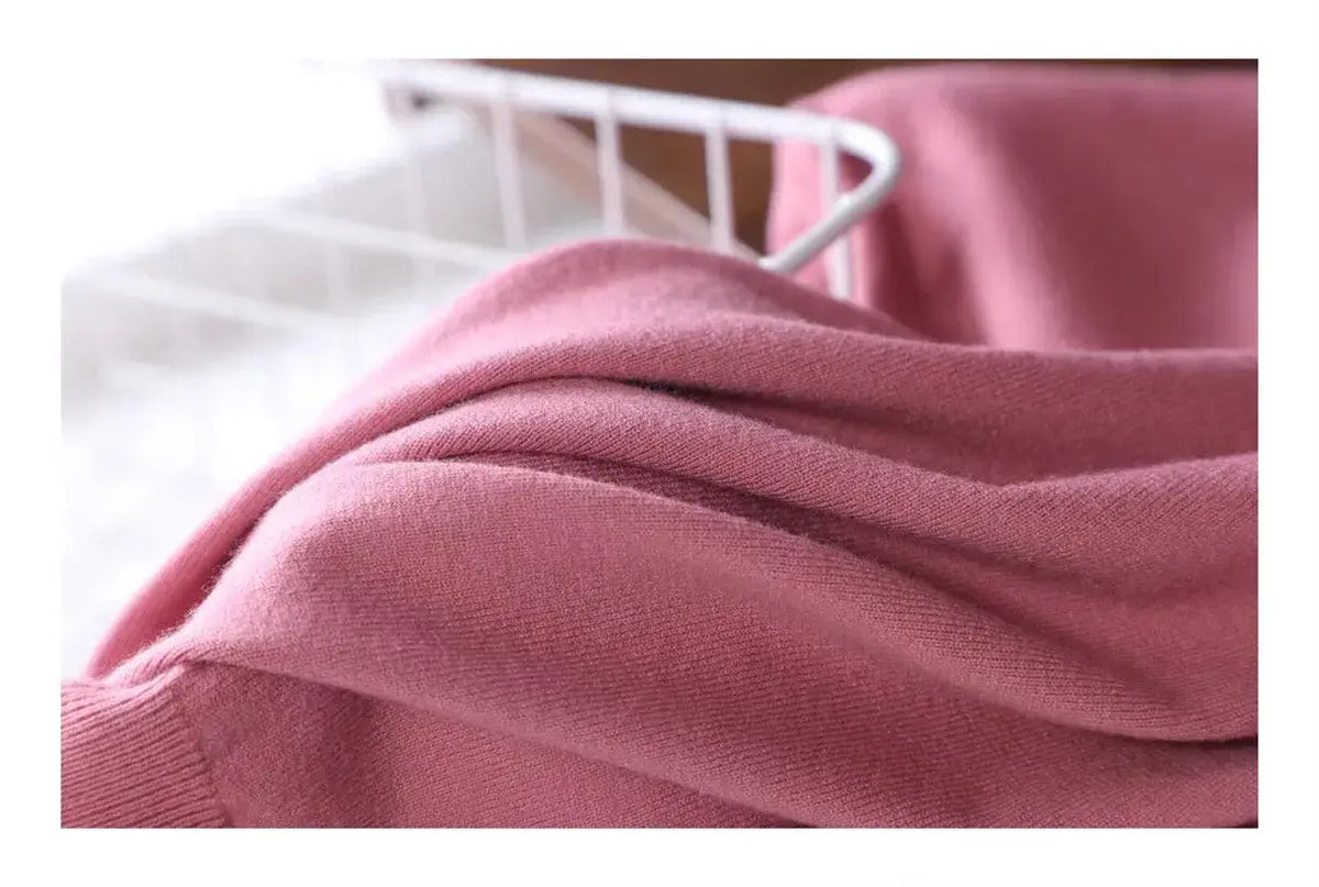 Close view of the soft knit fabric draping, dusty pink