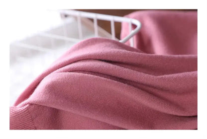 Close view of the soft knit fabric draping, dusty pink