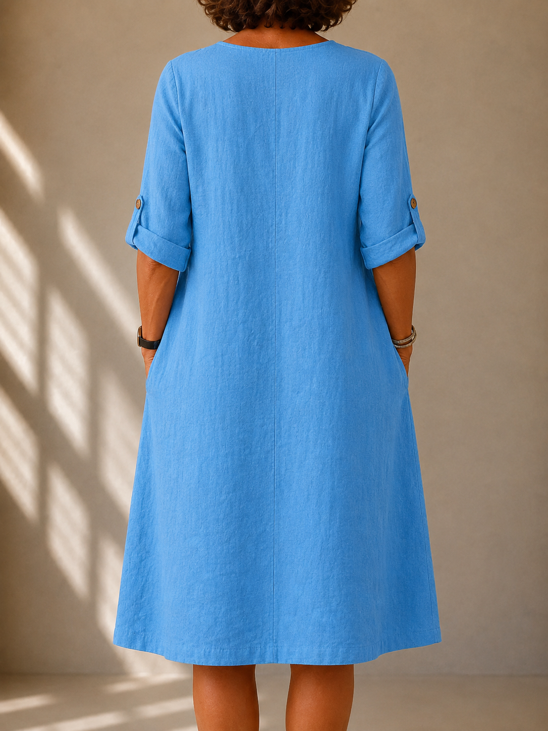Back view of the Nadine dress in Sky Blue, showing the A-line drape