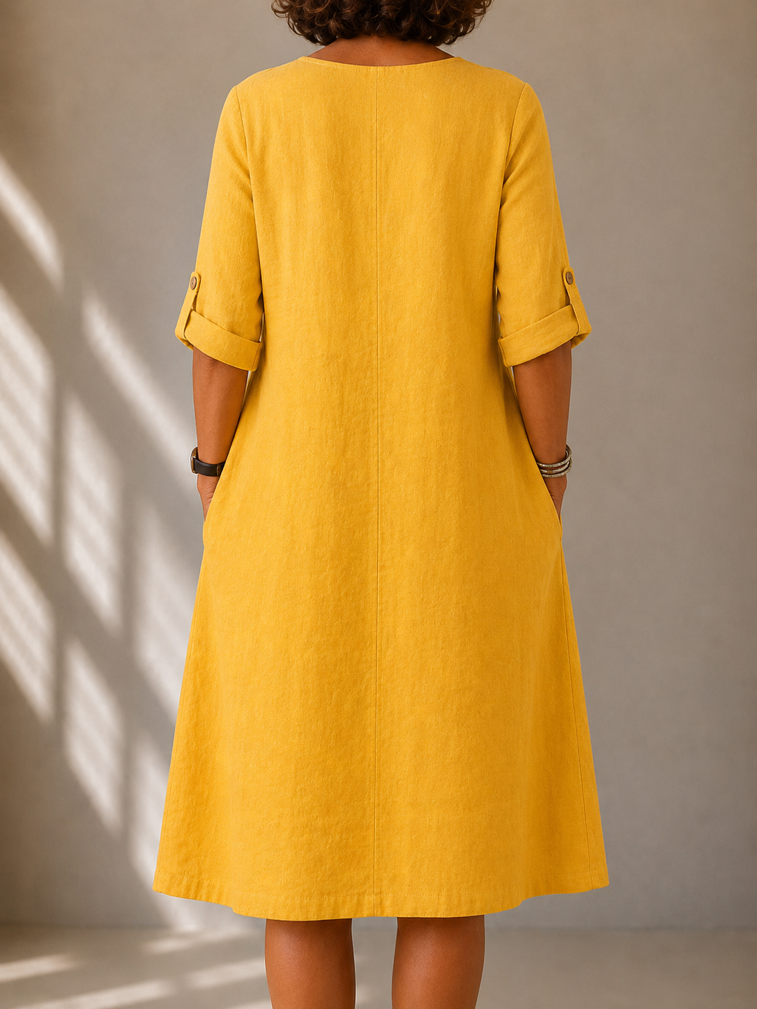 Back view of the Hazel dress in Mustard, showing the A-line drape