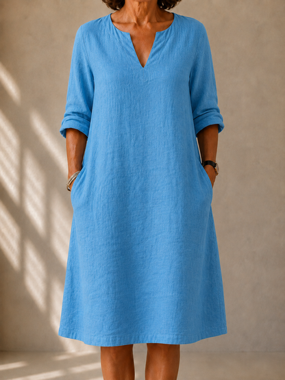 Nadine dress in Sky Blue, front view showing the split V-neck and rolled sleeves