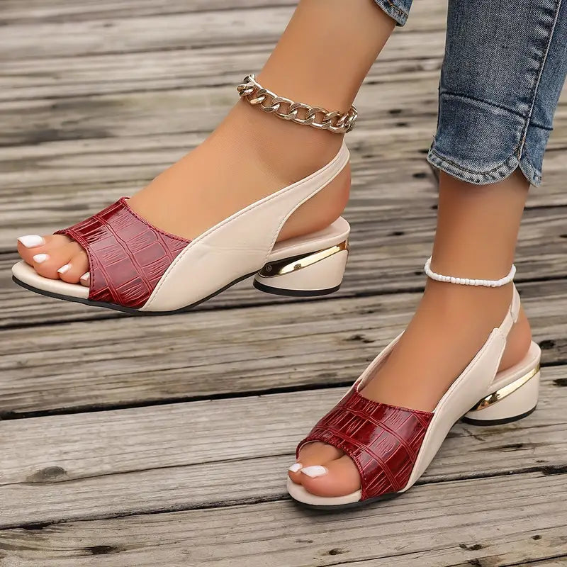 Colette sandal in burgundy, pair shown on a wooden deck