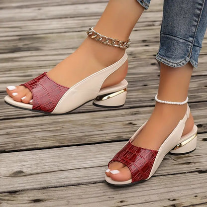 Colette sandal in burgundy, pair shown on a wooden deck