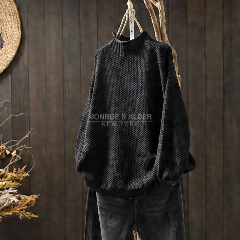 Esther sweater in black on a hanger
