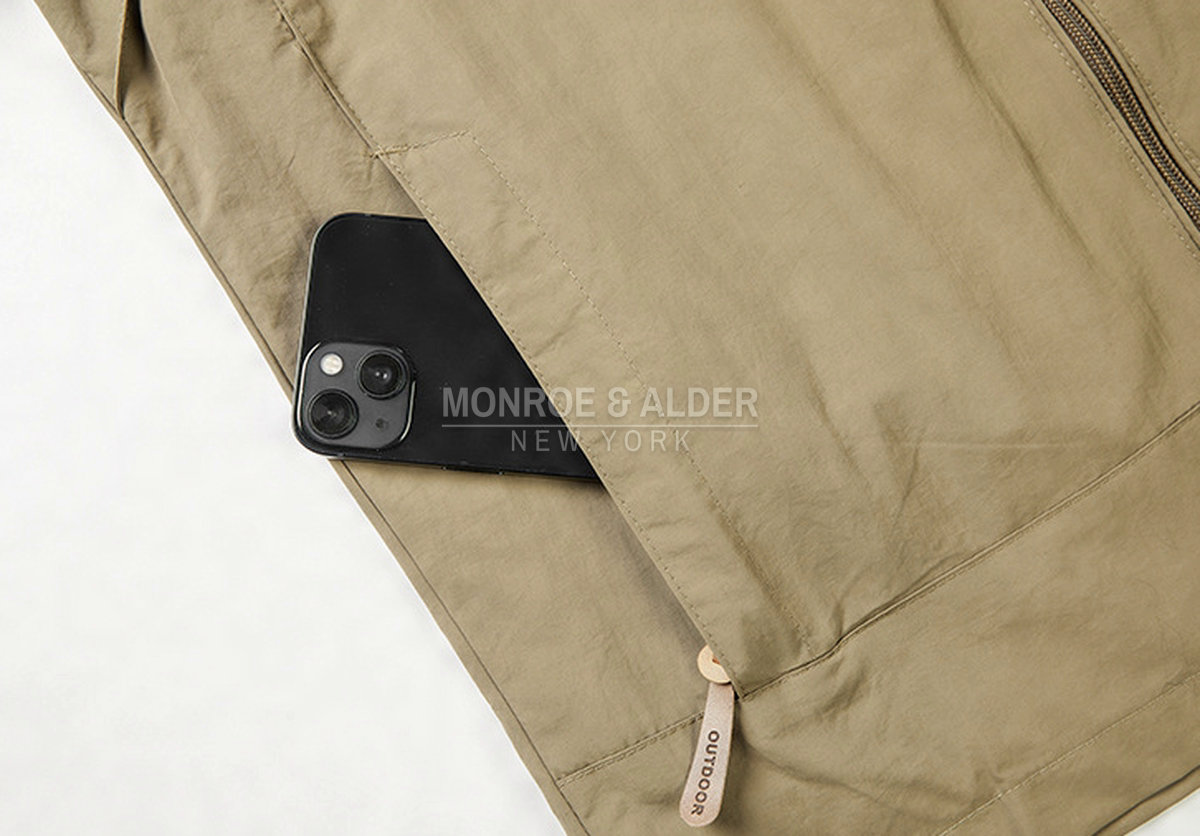 Close view of the zippered side pocket holding a phone