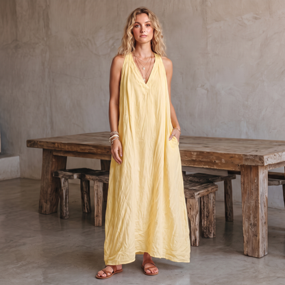 Avery linen-blend V-neck maxi dress in yellow, turned with a hand in the pocket