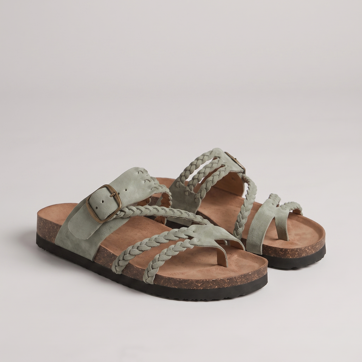 Hadley braided cork sandals in sage green, pair shown at an angle showing braided straps, toe loop and brass-tone buckle