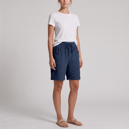 Woman wearing Josie navy crinkle cotton bermuda shorts with a white tee