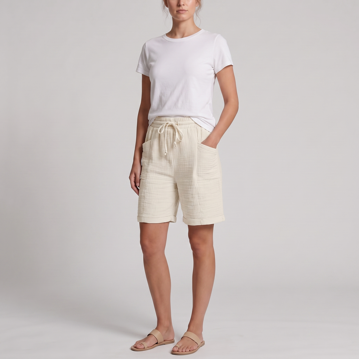 Woman wearing Josie ivory crinkle cotton bermuda shorts with a white tee