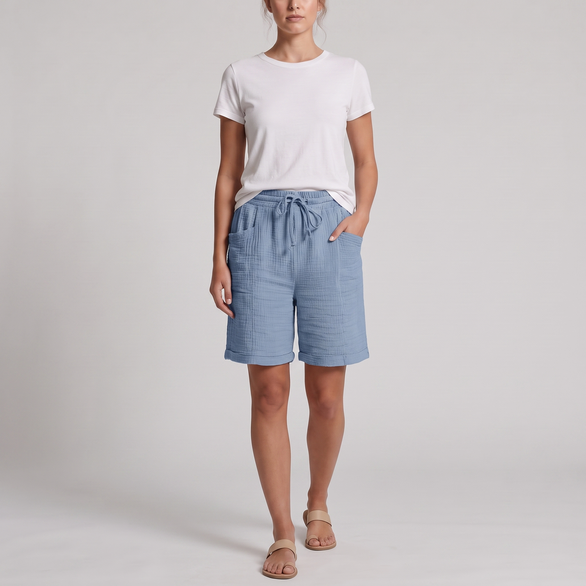 Woman wearing Josie light blue crinkle cotton bermuda shorts with a white tee