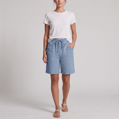 Woman wearing Josie light blue crinkle cotton bermuda shorts with a white tee