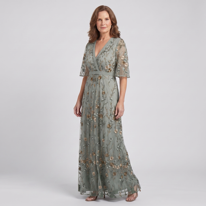 Nora sage green floral maxi dress, three-quarter view showing the defined waist and flowing skirt