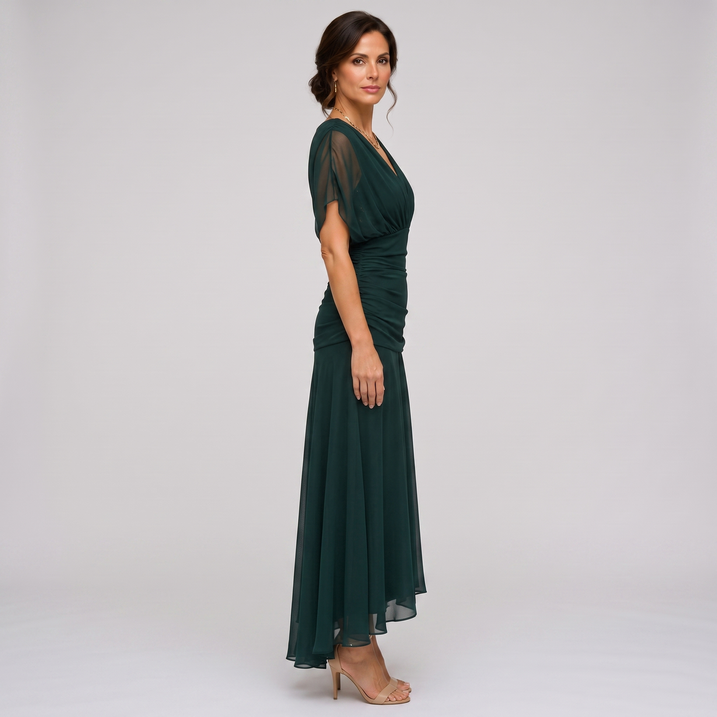 Clara dark green chiffon maxi party dress, side view showing the high-low hem