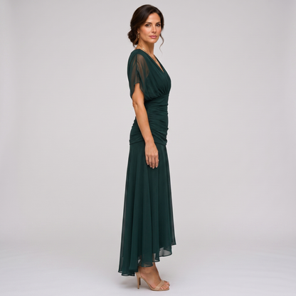 Clara dark green chiffon maxi party dress, side view showing the high-low hem