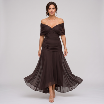 Clara dark brown chiffon maxi party dress worn off the shoulder, walking front view