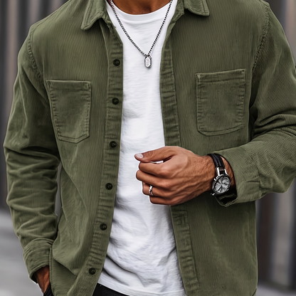 Man wearing the Brooks olive green corduroy overshirt over a white tee, cropped torso view
