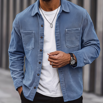 Man wearing the Brooks blue corduroy overshirt over a white tee, cropped torso view