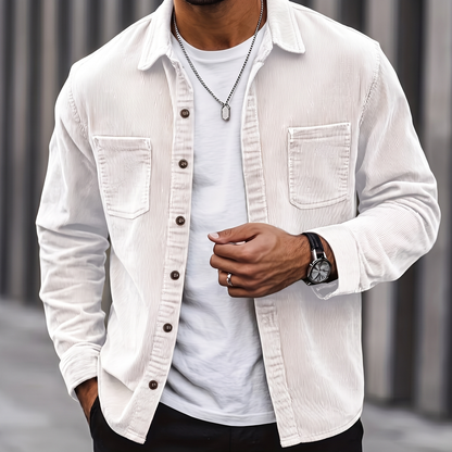 Man wearing the Brooks white corduroy overshirt over a white tee, cropped torso view