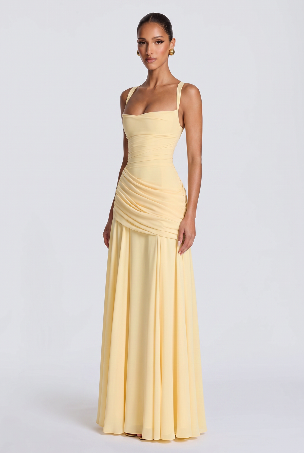 Genevieve maxi dress in butter yellow, three-quarter view showing the draped hip