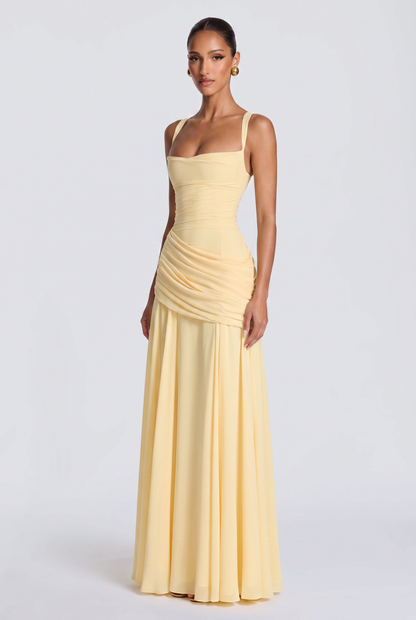Genevieve maxi dress in butter yellow, three-quarter view showing the draped hip