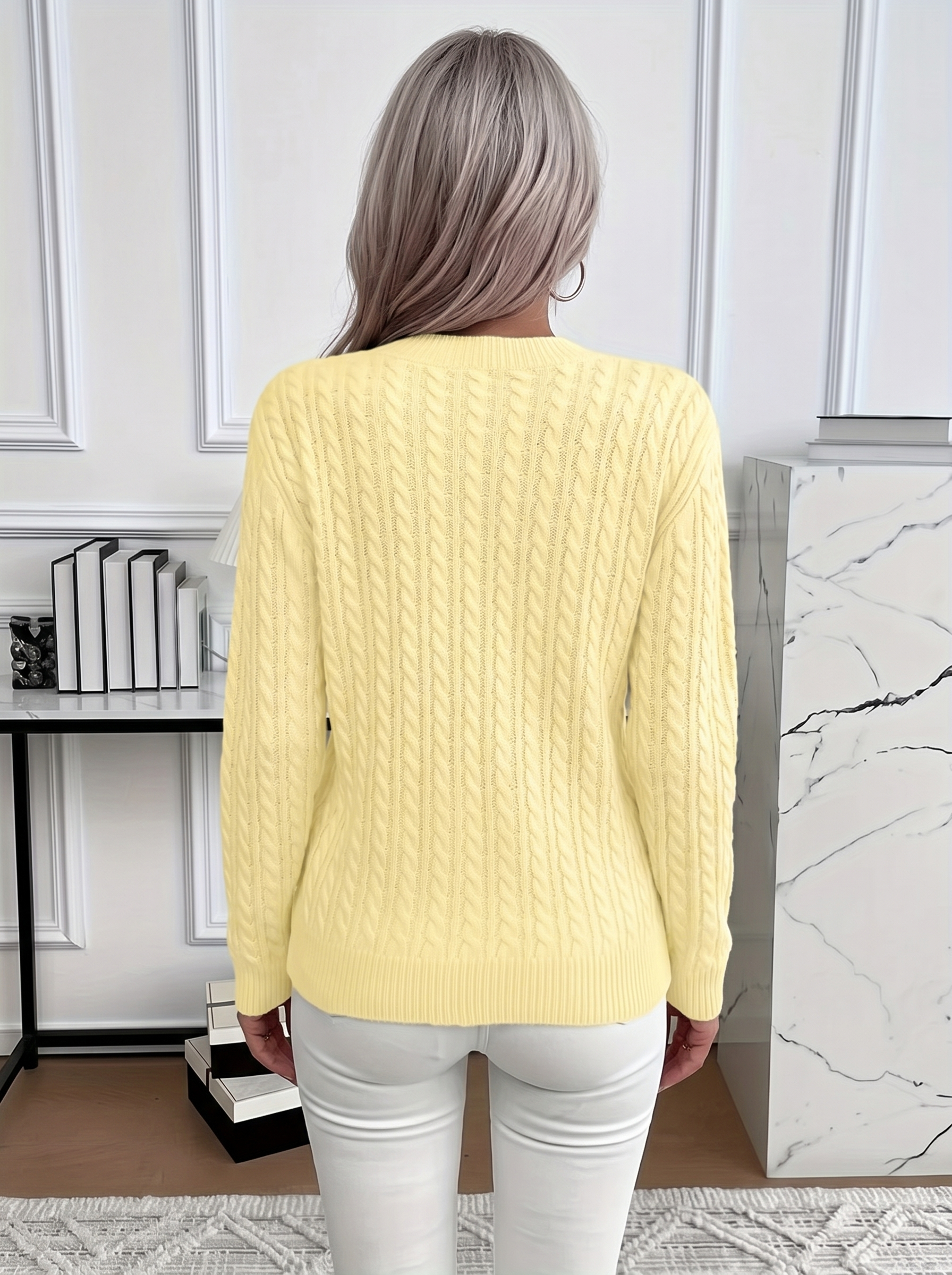 Back view of the Evelyn cozy cable knit sweater in pale yellow