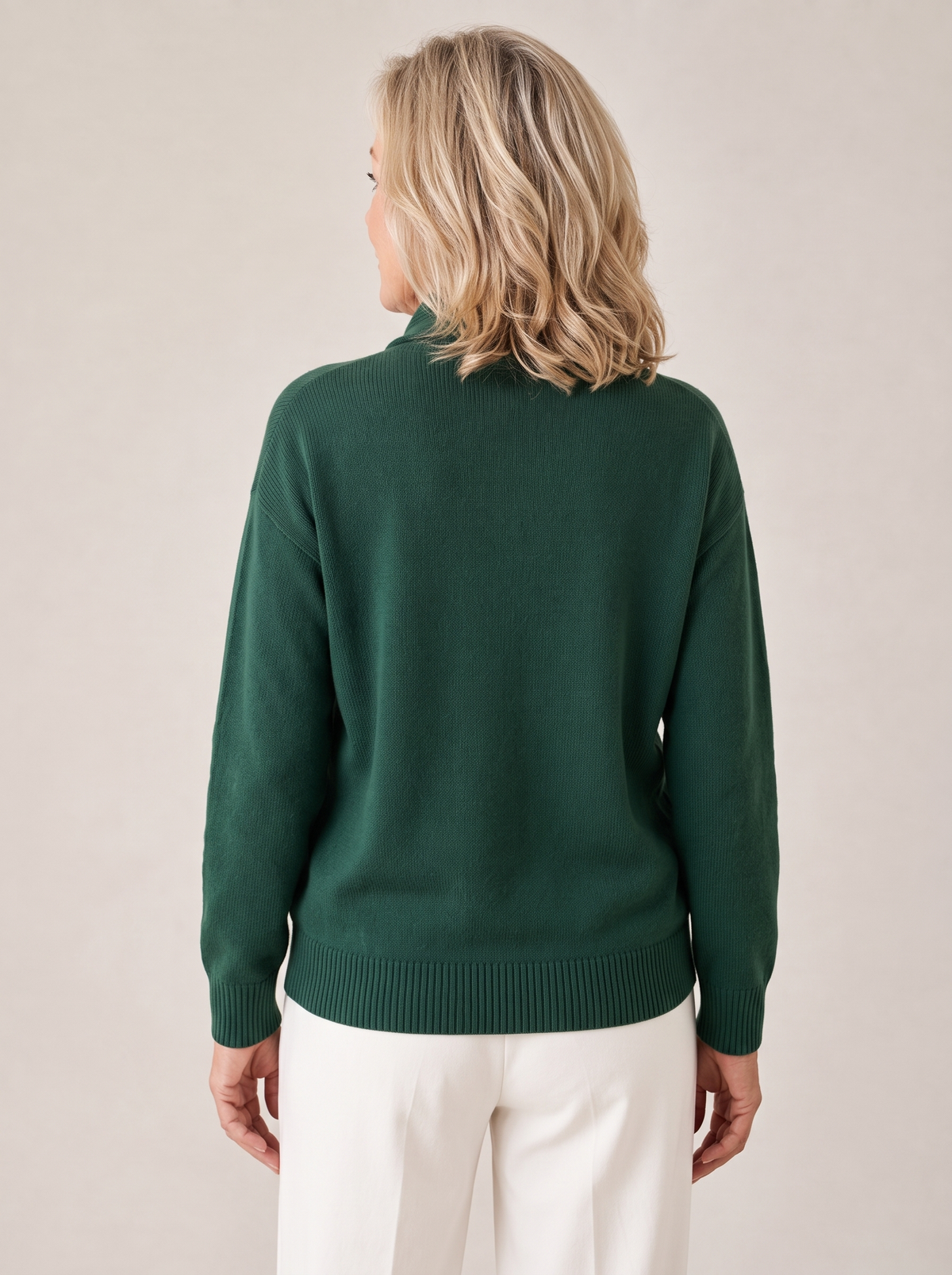 Back view of the Greta sweater in forest green with ribbed hem