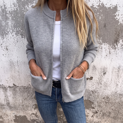Sylvia zip-front knit cardigan in Heather Gray, worn open over a white tee with hands in the patch pockets