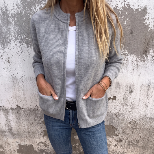 Sylvia zip-front knit cardigan in Heather Gray, worn open over a white tee with hands in the patch pockets