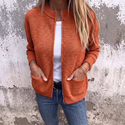 Sylvia zip-front knit cardigan in Rust, front view showing the ribbed cuffs and patch pockets