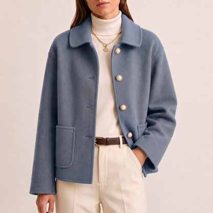 Myrna cashmere crop coat in Dusty Blue, worn open over cream trousers and a brown belt