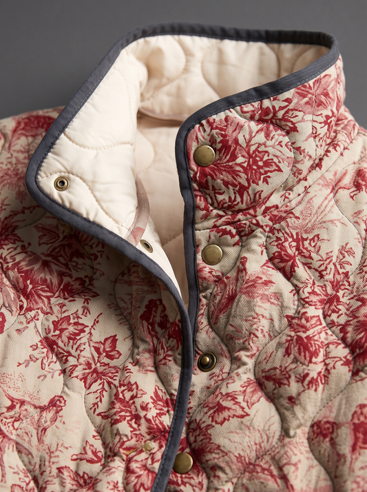 Close view of the stand collar, brass snaps and cream quilted lining on the Ruth jacket