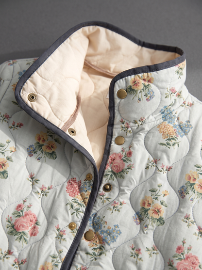 Close view of the stand collar, brass snaps and cream quilted lining on the Daphne jacket