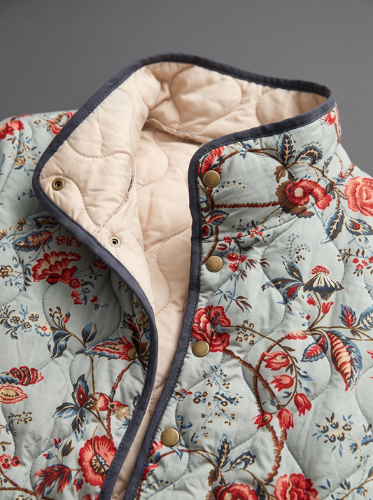 Close view of the stand collar, brass snaps and cream quilted lining on the Martha jacket